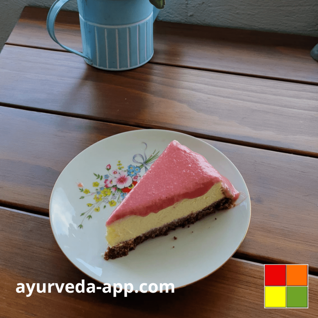 Photo of cheesecake with strawberry topping on a white floral plate