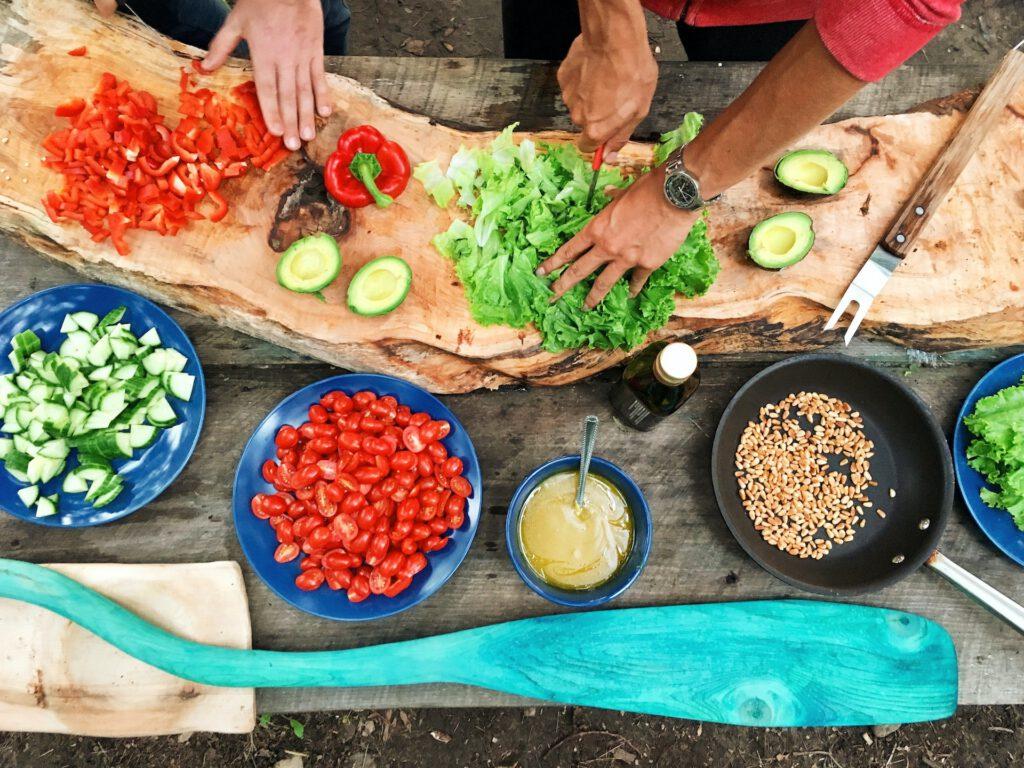 Image of two people cooking healthy and natural food. Ayurveda values ​​cooking with natural foods that balance the body and mind.