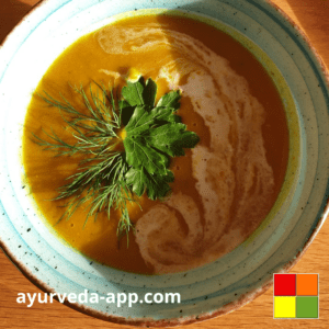 Photo of a blue bowl with a brown rim of Sweet Potato Coconut Soup