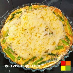 Photo of Green asparagus frittata in a glass baking dish.