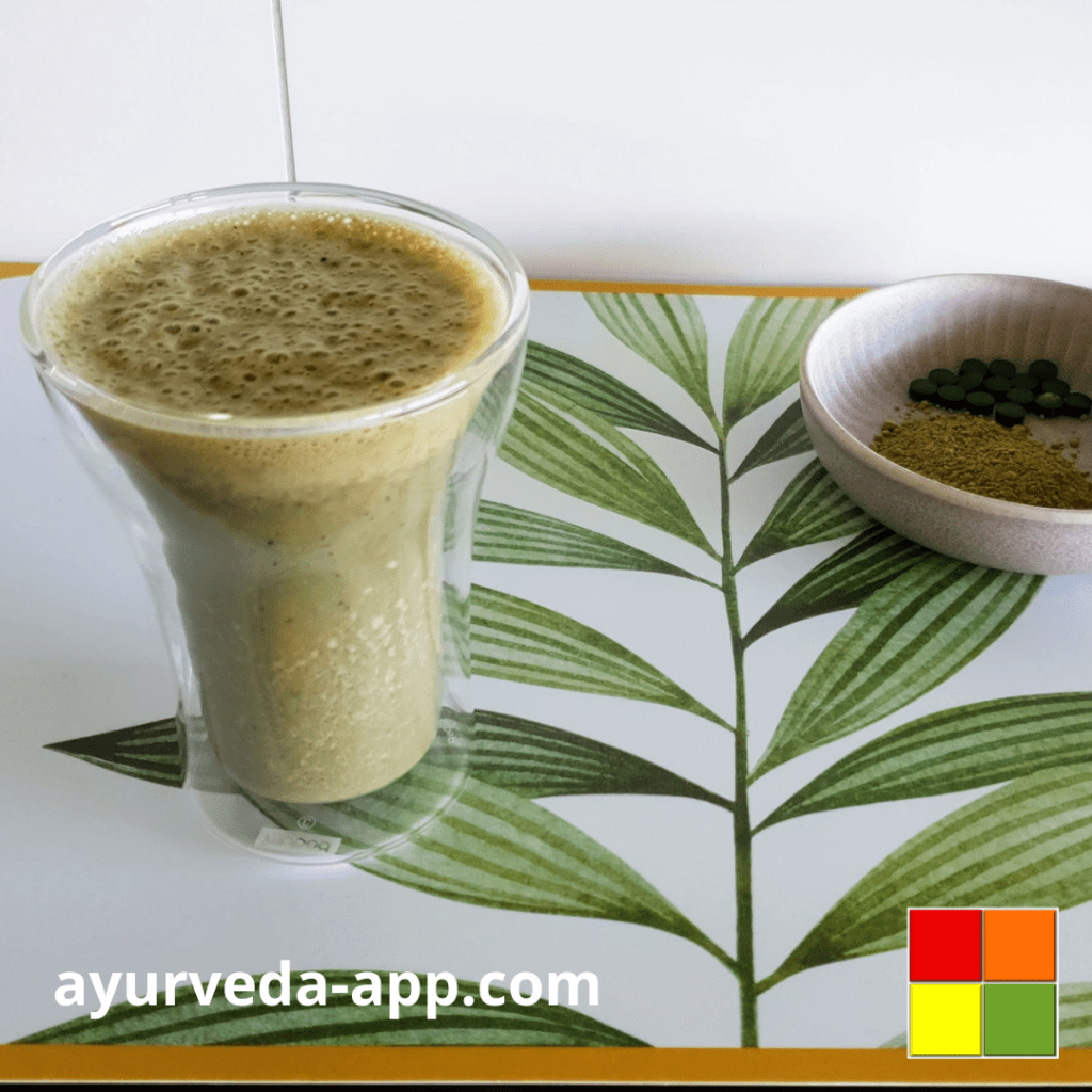 Photo of Wake me up smoothie served in a double glass tumbler. In the picture, there is also a bowl with matcha powder.