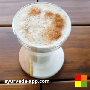 Photo of Cashew Banana Smoothie served in a double glass cup.