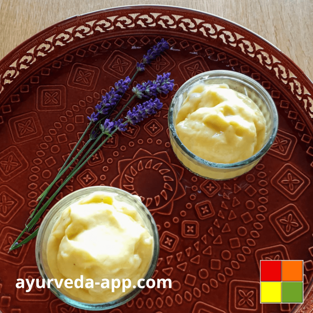 Photo of two bowls of Mango banana ice on a decorated red tray, along with lavender flowers to decorate.