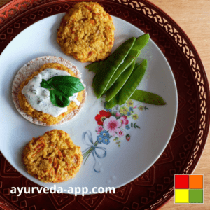 Photo of a flowery plate with millet patties and string beans. The dish is on a tray.