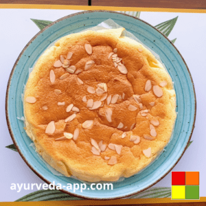 Photo of Low-carb yogurt sponge cake with almond flakes on top on a blue plate with brown border