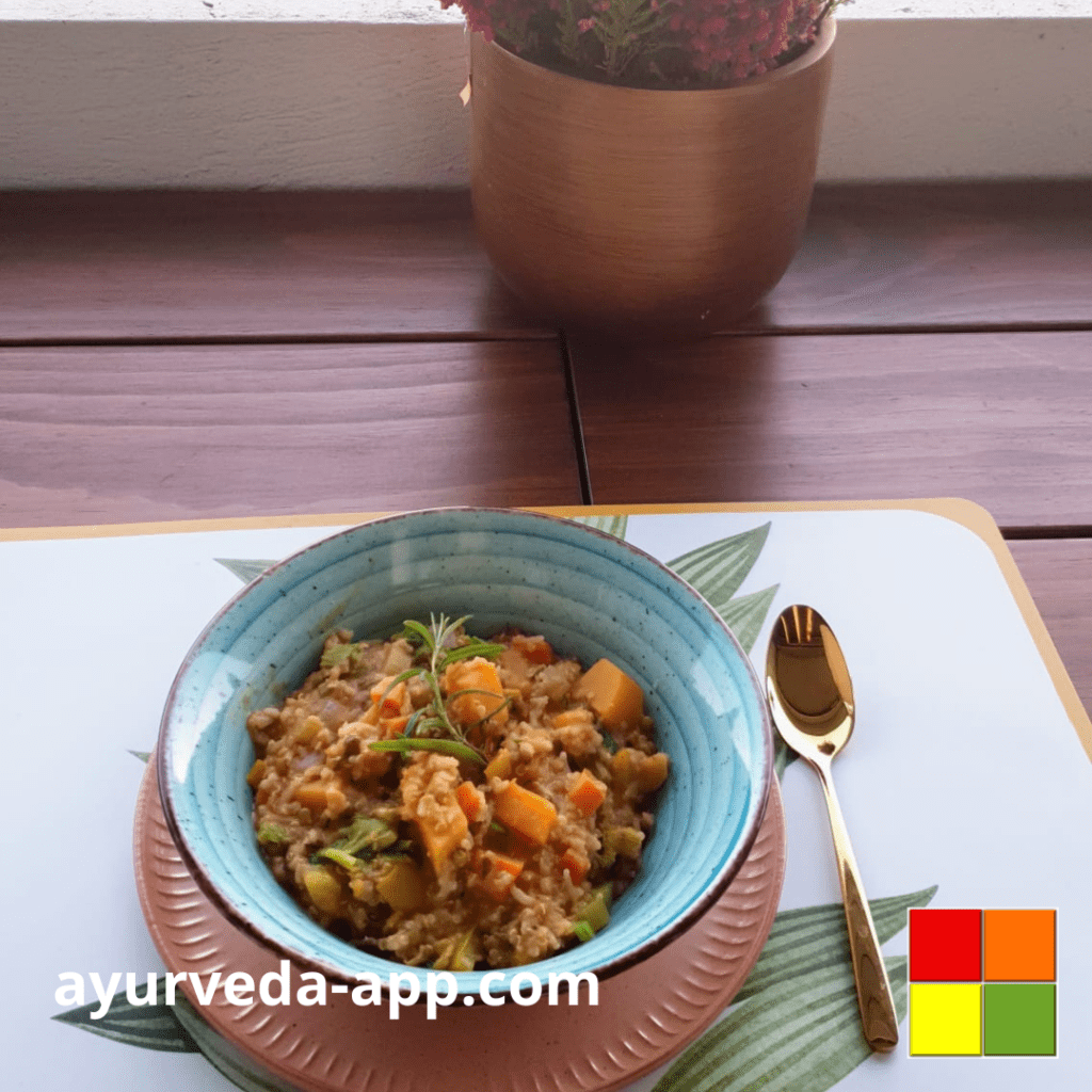 photo of Mung beans stew with pumpkin and rice on a blue plate with brown border. Next to the plate is a golden spoon