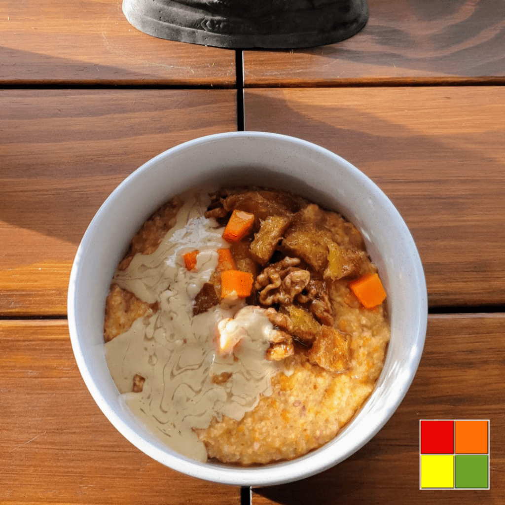 photo of a white bowl of Pumpkin-spice porridge on a wooden table