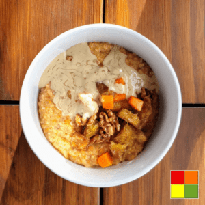 photo of a white bowl of Pumpkin-spice porridge on a wooden table