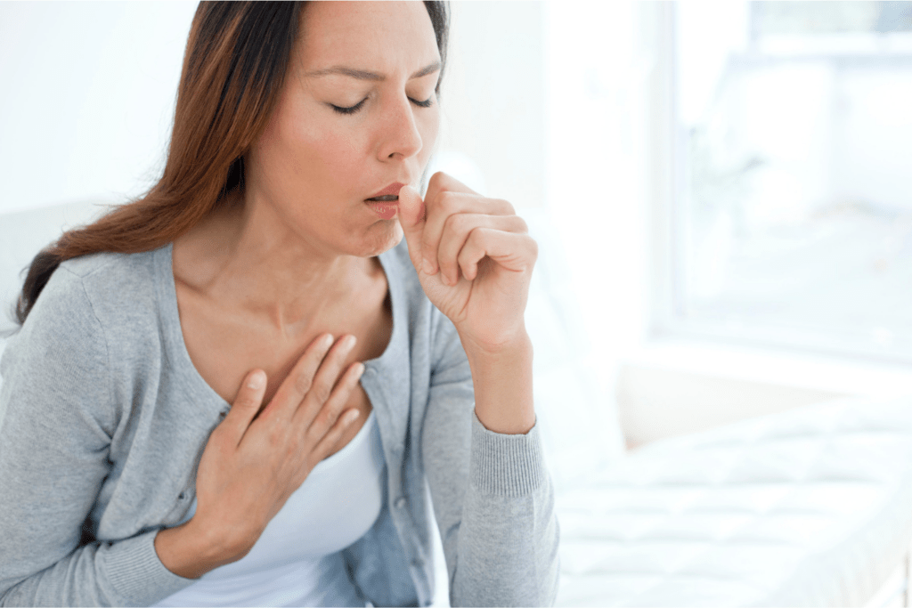 photo of a young woman coughing. You can improve Coughing with natural Ayurvedic remedies for coughing