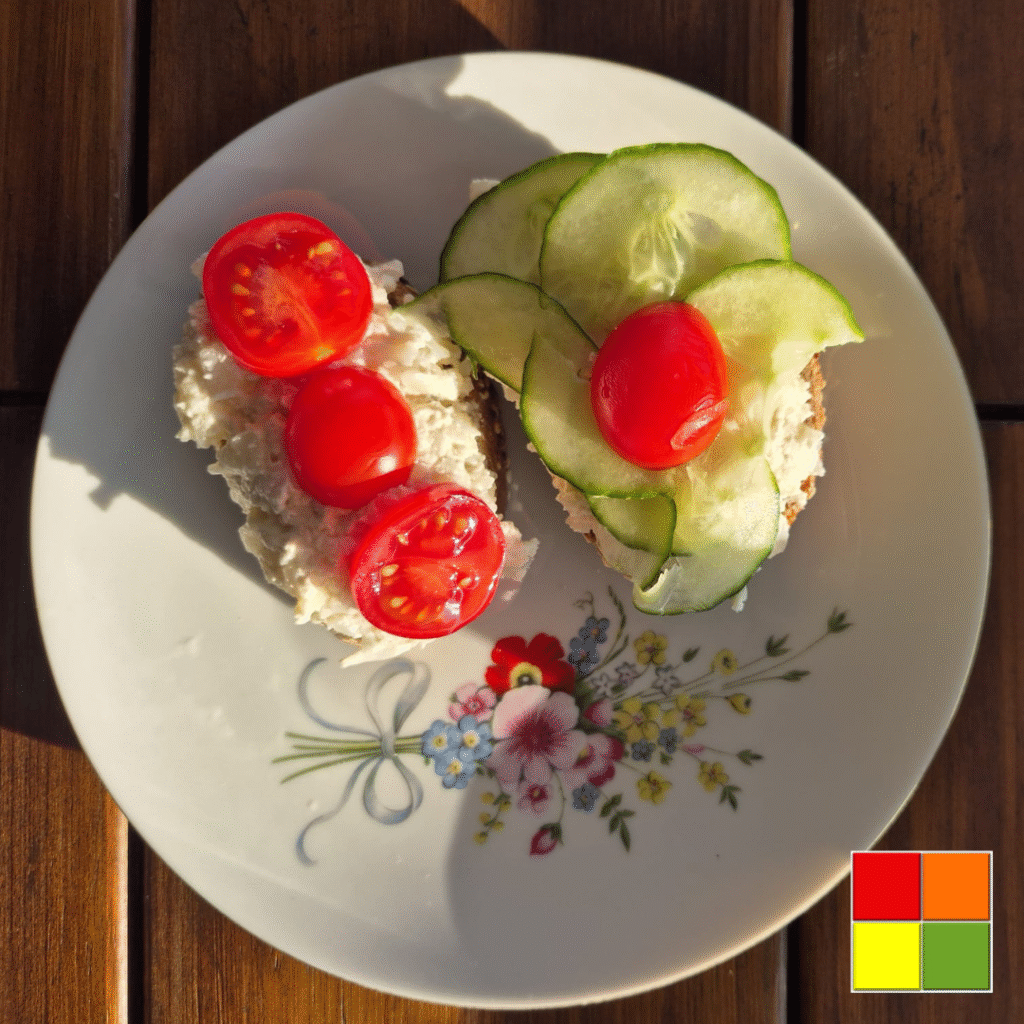 Two slices of bread topped with Cauliflower Spread with Vegan Cashew Mayo, cucumber, and tomato