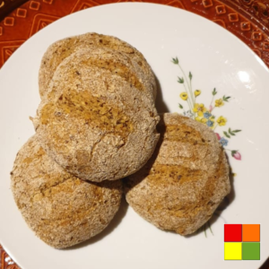 Low Carb Bread Rolls arranged on a white floral plate, showing three rustic golden-brown, grain-free bread rolls.