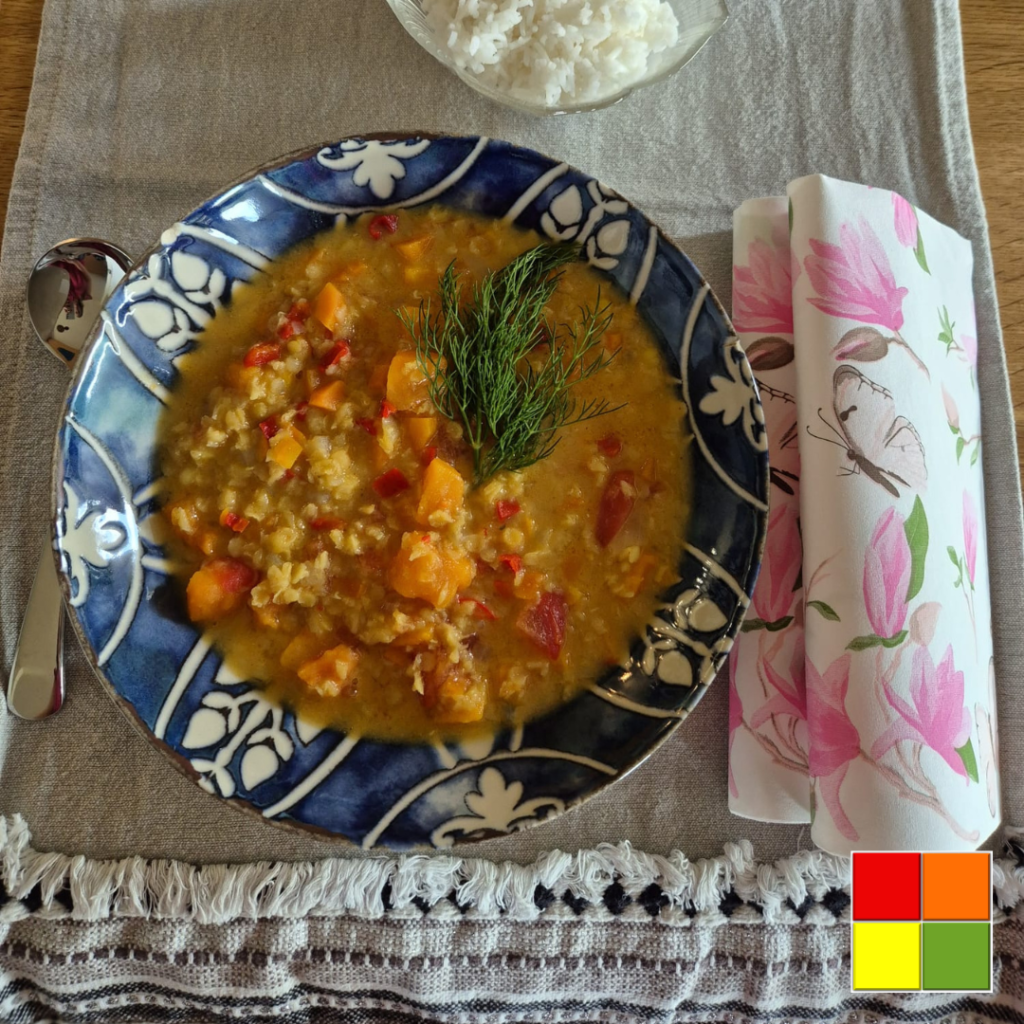 Red Lentil Dal with Sweet Potato served with white rice and garnished with fresh dill for a warm and comforting Ayurvedic meal.